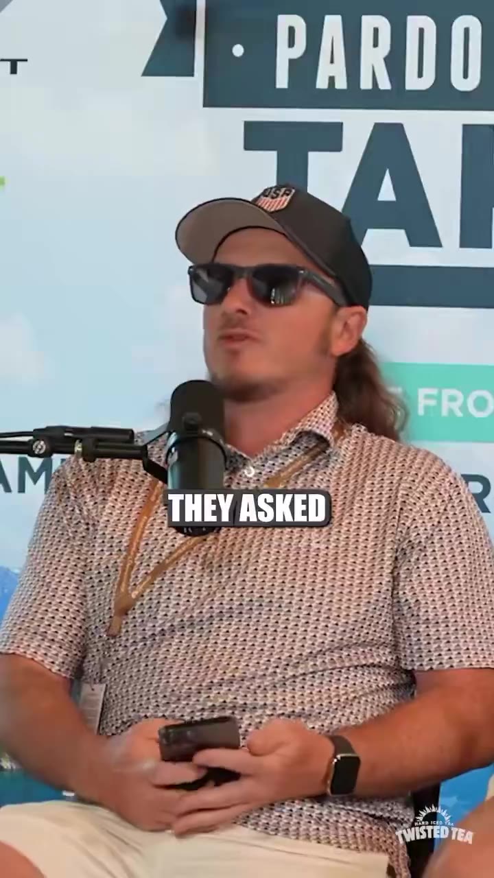 Two men sit on stools with microphones in front of a 'Pardon My Take' branded backdrop with 'Live From the' event signage and Chevrolet sponsor logo, talking on stage with captions reading 'IT WAS?', 'BUT A LOT OF', and 'THE WHOLE REGION' displayed on screen.