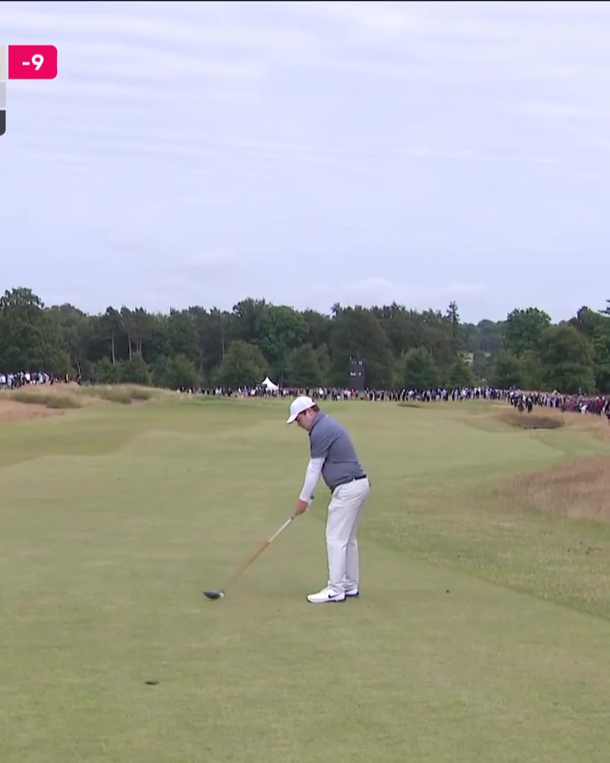 A golf ball rolls across a green toward the hole on a par-5 marked 549 M, with another ball already resting near the cup as a player in shorts and white shoes stands nearby watching.