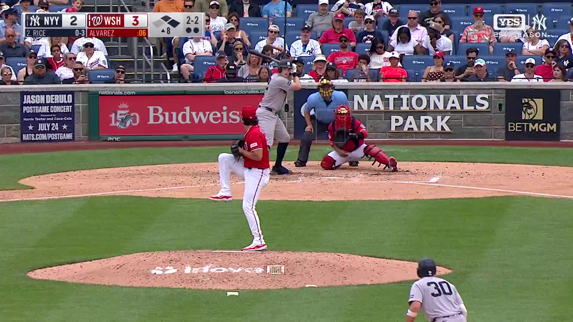 Washington outfielder in red jersey chasing down a fly ball hit deep to the outfield, then a Yankees baserunner in gray crossing home plate as a Washington catcher looks on, with the scoreboard showing Yankees 4, Washington 3 in the 8th inning.