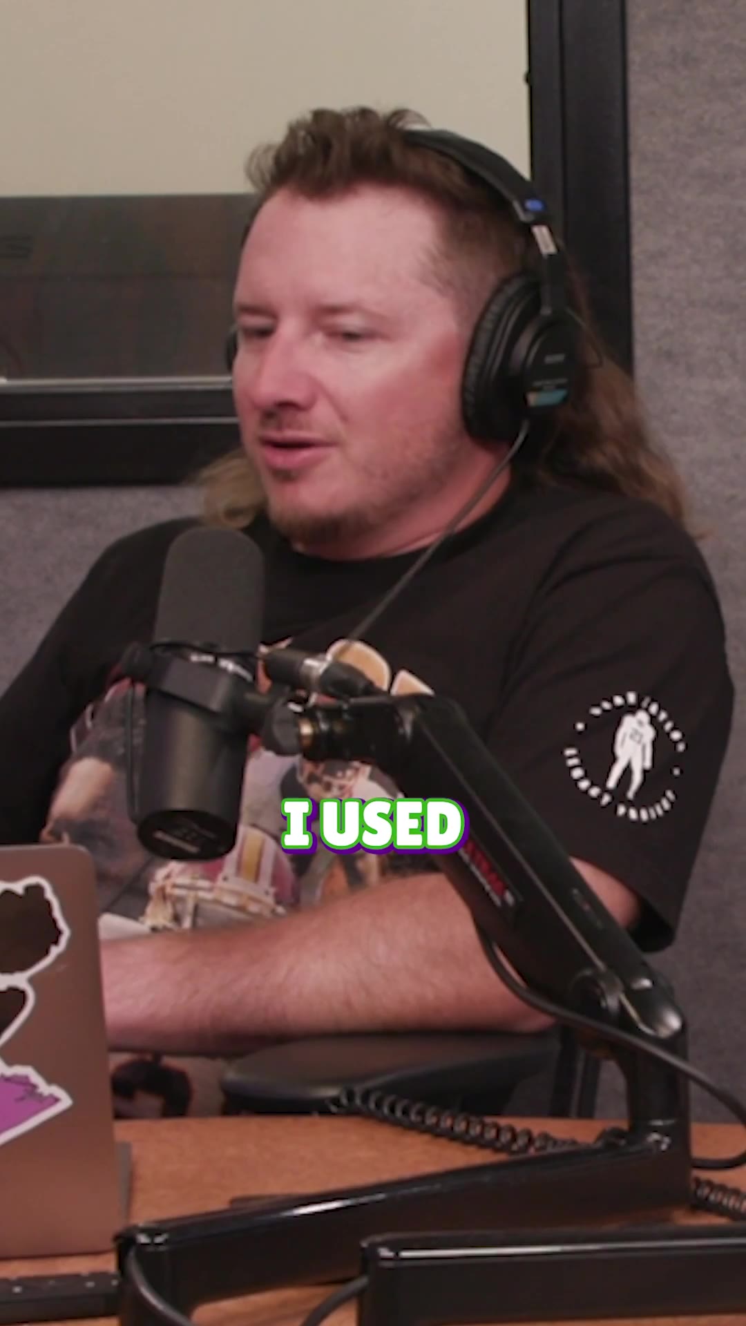 Two men wearing headphones sit at a podcast desk with microphones and a laptop, mid-conversation; on-screen captions read 'WE FELL BACK', 'ROLLS AROUND', and 'YOU FEEL'.