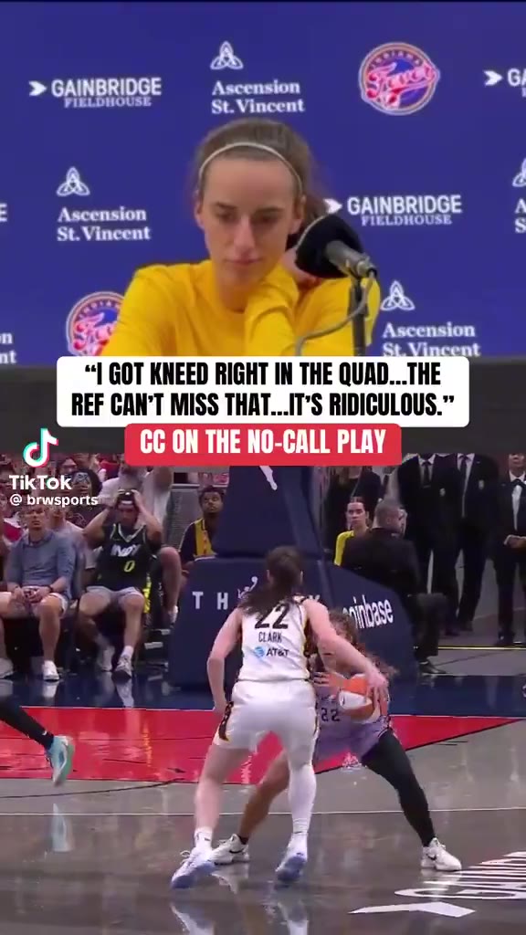 A press-conference clip of a WNBA player in a yellow shirt at a podium with a quote about being kneed in the quad and no call, followed by in-game footage of players in white/gold and lavender/purple jerseys near the basket, including a player wearing number 41.