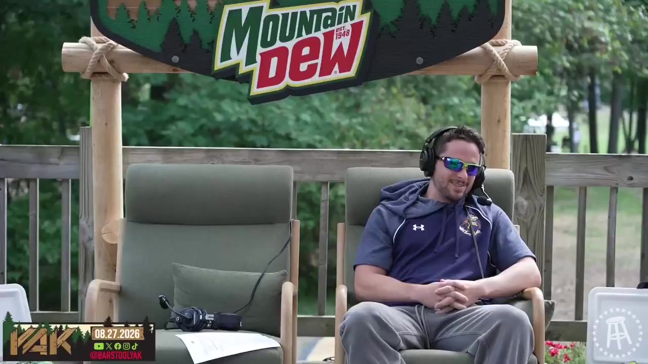 Three men wearing headsets sit outdoors on a wooden deck under a Mountain Dew branded wooden arch, laughing and talking during what appears to be a podcast recording; another frame shows two men in headsets seated in the same outdoor setup, one wearing mirrored sunglasses and a hoodie, coolers with drinks visible nearby.
