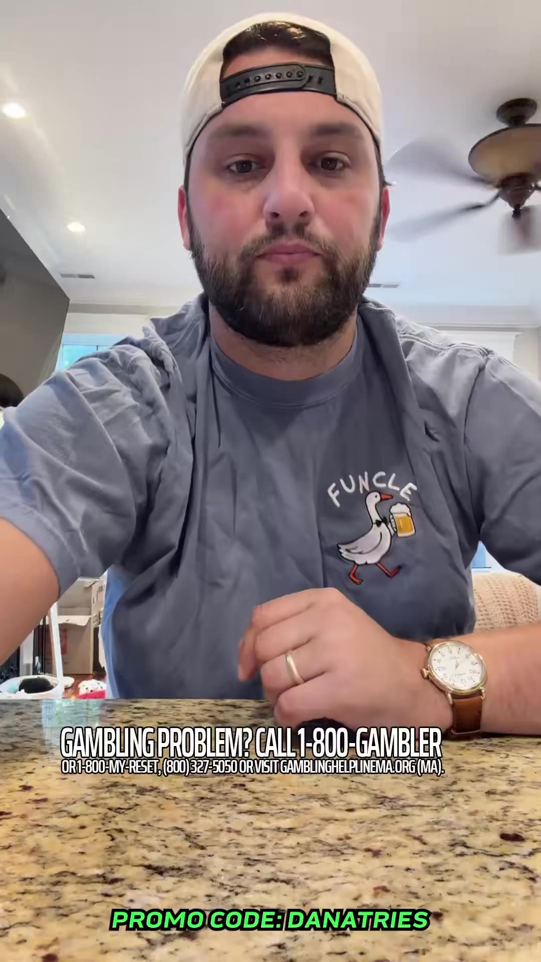 A man in a backwards cap tastes cubed tofu from a takeout container, reacting with a squinted, displeased facial expression before picking up another piece.