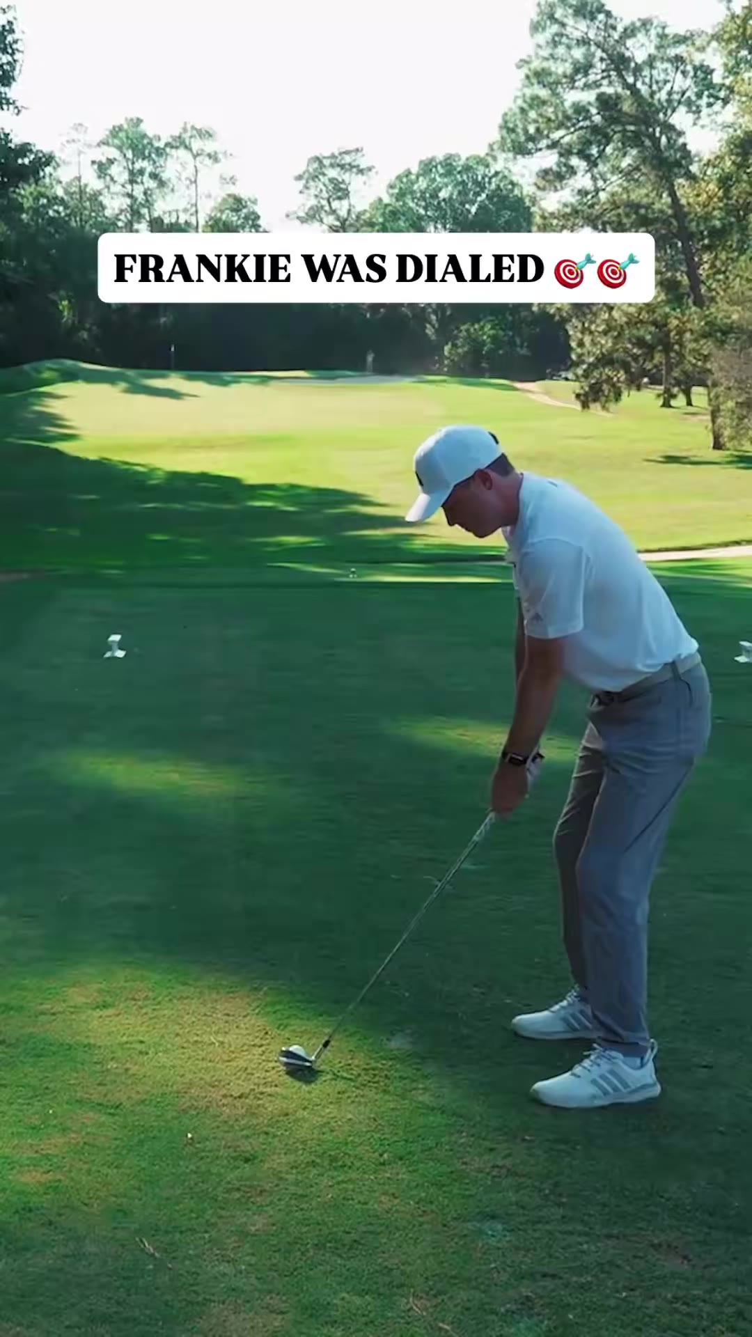 A man in a white cap and patterned polo drives a golf cart while talking to a passenger, cut with a shot of a flag on a putting green and a fist bump with another cart passenger.
