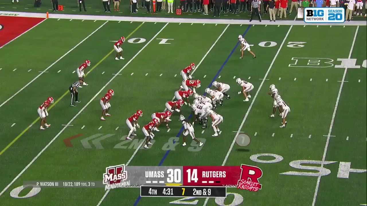 UMass wide receiver number 14 scores a touchdown against Rutgers, celebrating in the end zone as a referee looks on; scoreboard reads UMASS 36, RUTGERS 14, 4th quarter 4:27